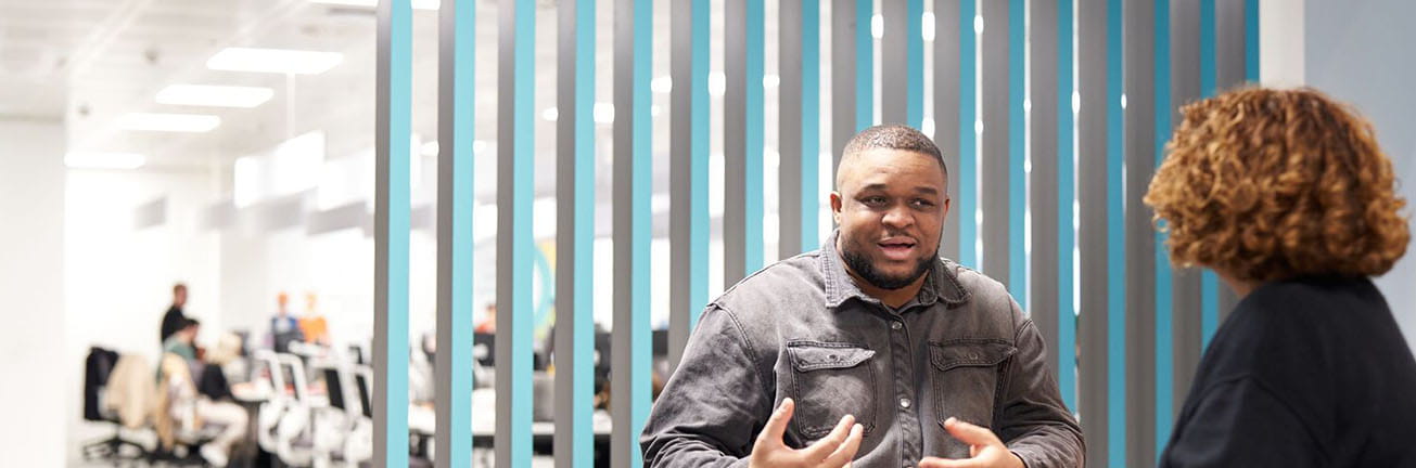 A man and a woman discuss cybersecurity in a modern office, highlighting digital safety, risk management, and secure business operations. A man and a woman discuss cybersecurity in a modern office, highlighting digital safety, risk management, and secure business operations.