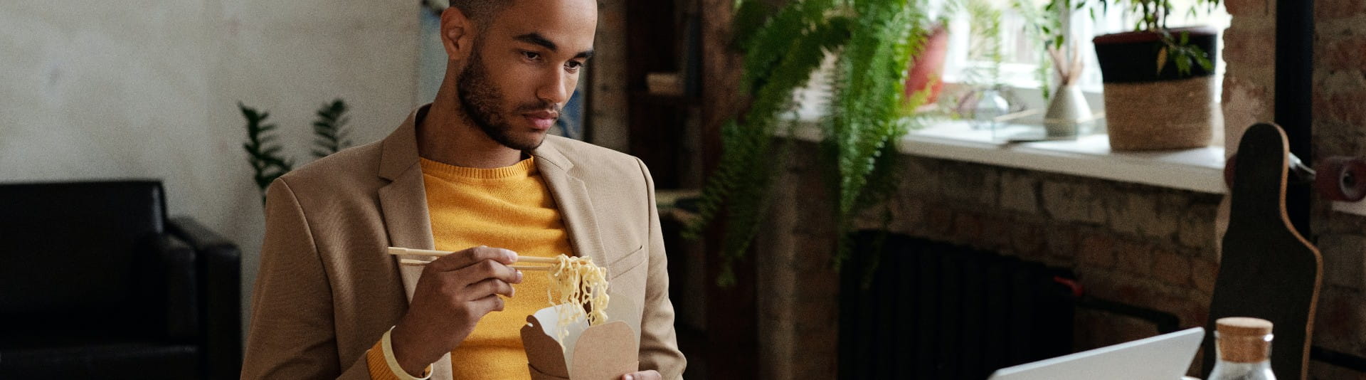 BANNER - Man Eating Lunch while remote working BANNER - Man Eating Lunch while remote working